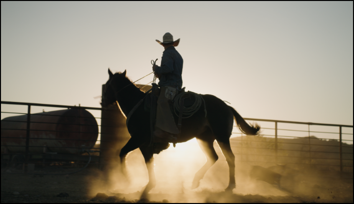 A man who is horse back riding.