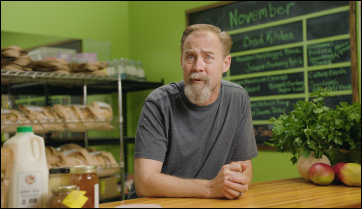 Store Owner at the front counter.
