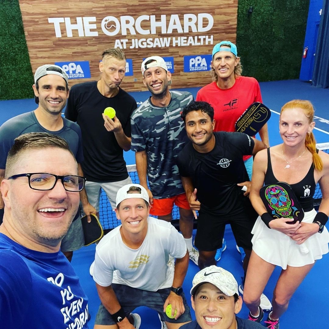 group of pickleball players smiling together