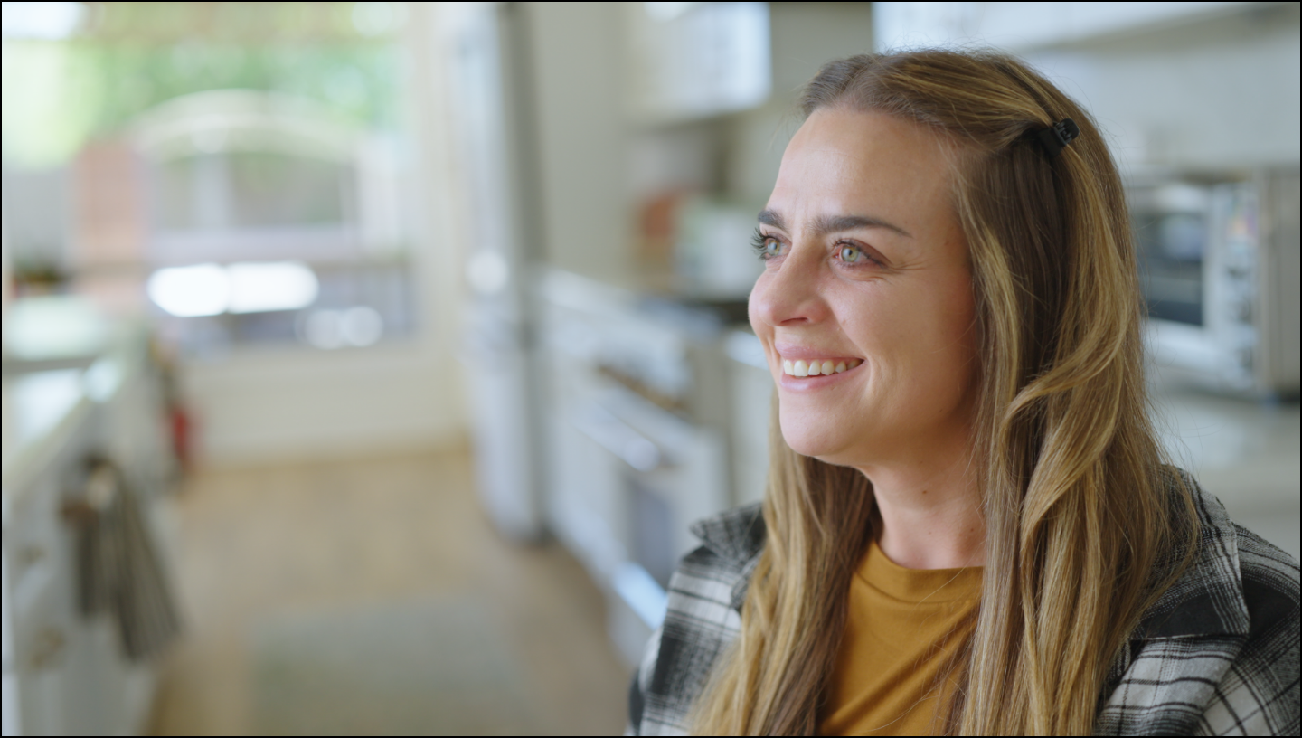 Woman smiling in a kitchen setting