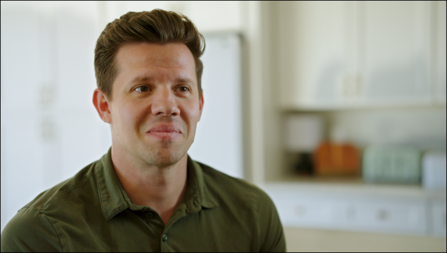 Man wearing a green shirt in a kitchen setting