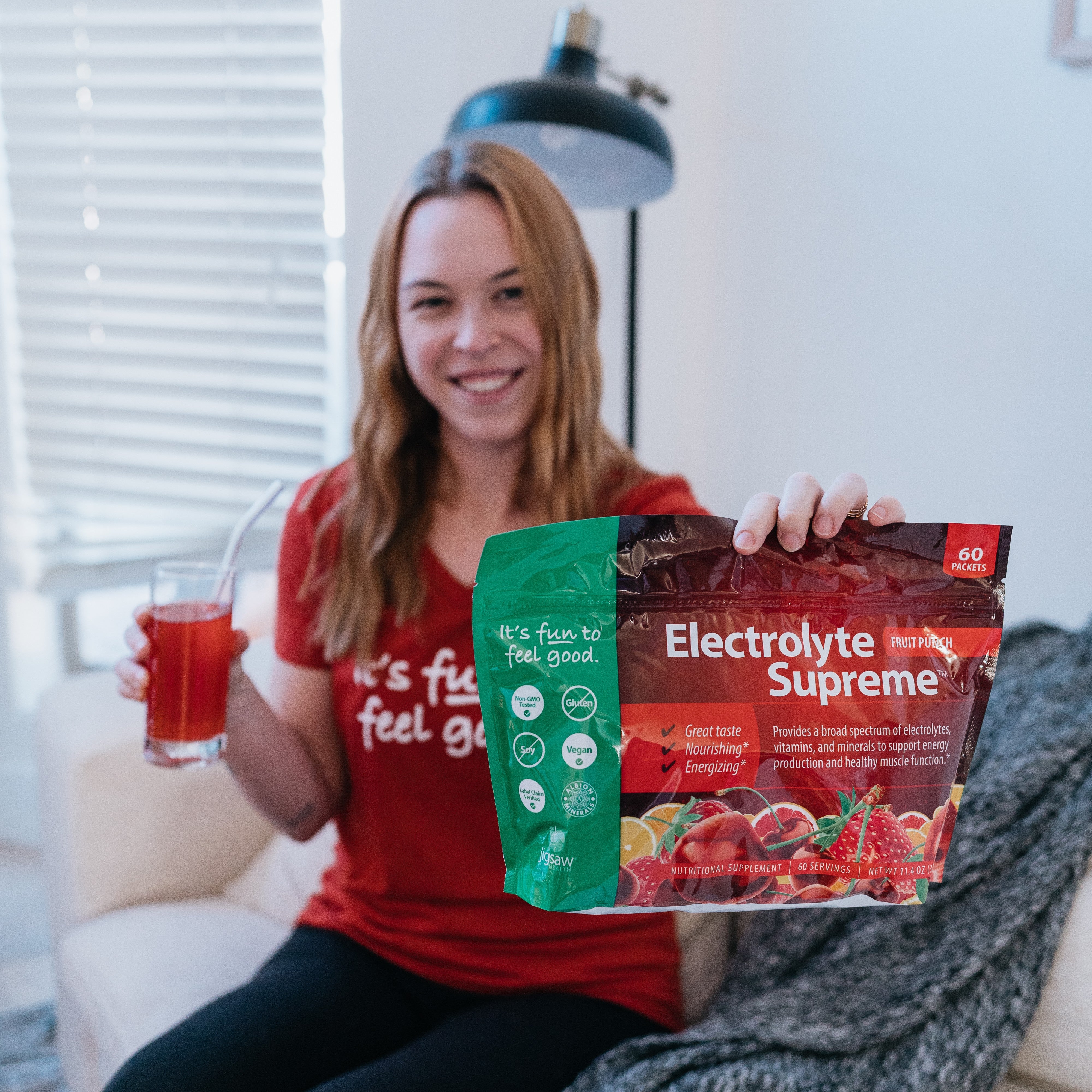 Woman holding Electrolyte Supreme Fruit Punch Bag