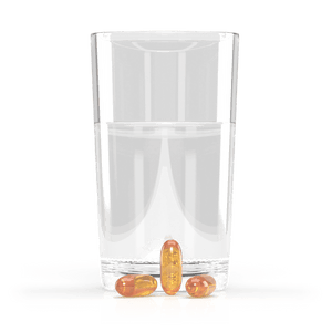 Jigsaw Alaskan Cod Liver Oil softgels next to a glass of water
