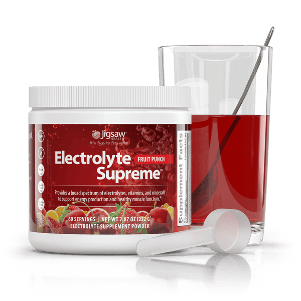 Jigsaw Electrolyte Supreme Fruit Punch jar and scoop next to a glass of water