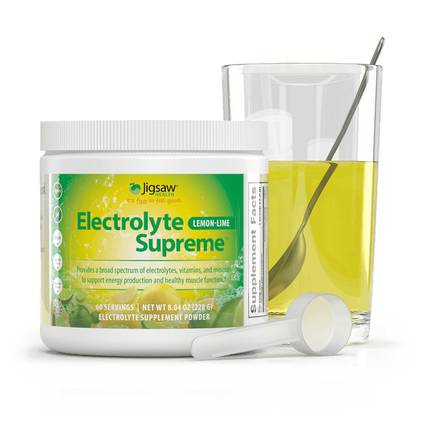 Jigsaw electrolyte supreme lemon lime glass with spoon next to jar and scoop