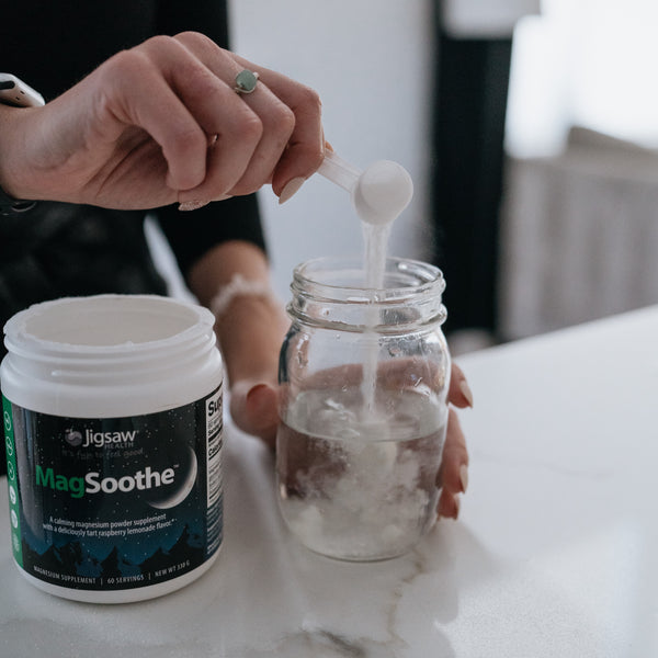 Person pouring MagSoothe scoop into water glass